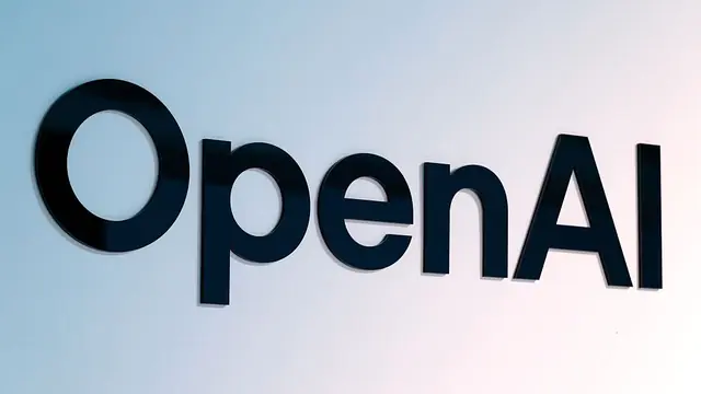 OpenAI logo lettering in black on a frosted glass wall