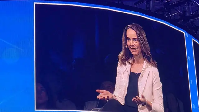 Sarah Friar, OpenAI CFO, speaking on stage, shown on a large conference screen
