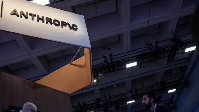 Anthropic sign on an exhibition booth inside a large convention hall